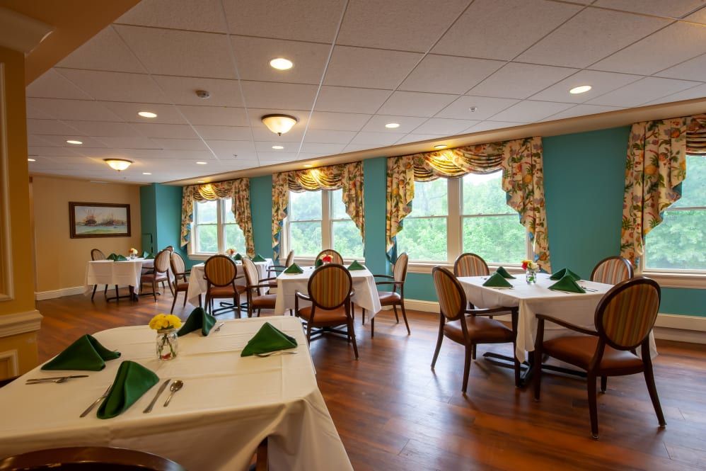 Elegant dining room with neatly arranged tables and decorated windows.
