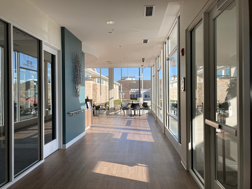 A bright and modern lobby with large windows, showcasing a spacious design.