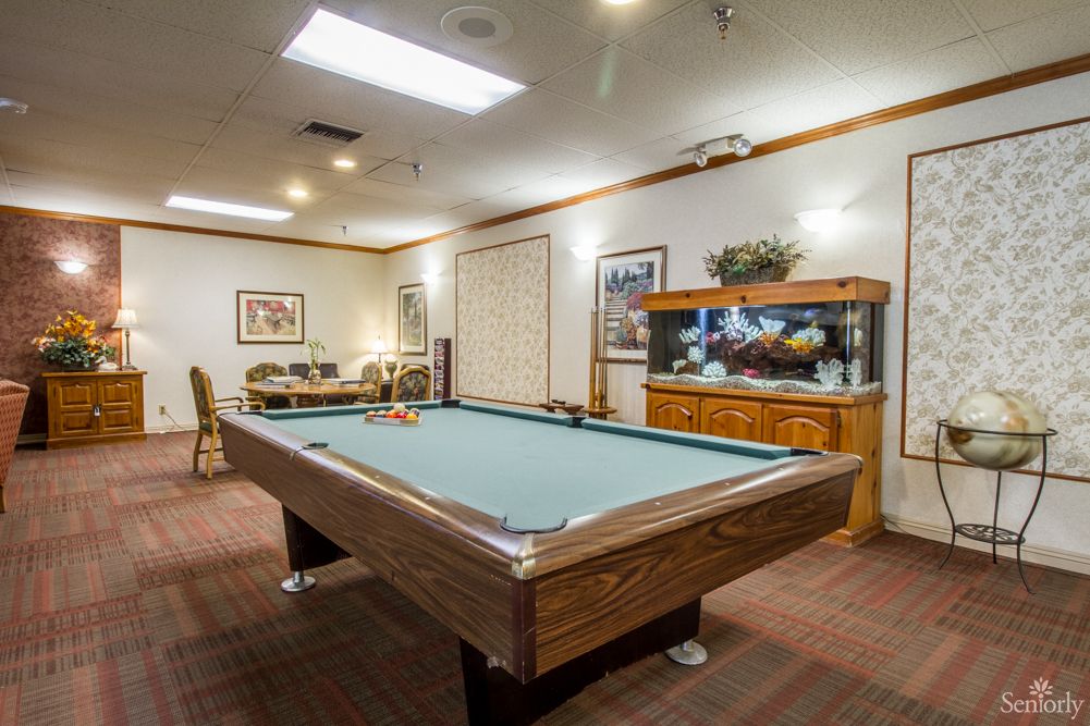 A cozy game room featuring a pool table and an aquarium.