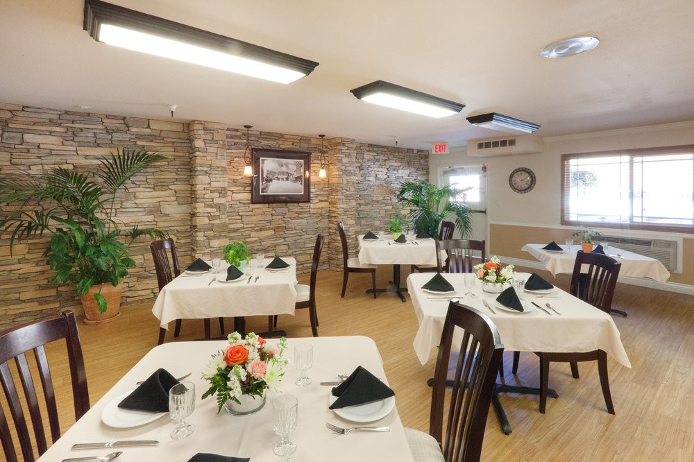An elegant dining area with neatly arranged tables and chairs, featuring tasteful decor.