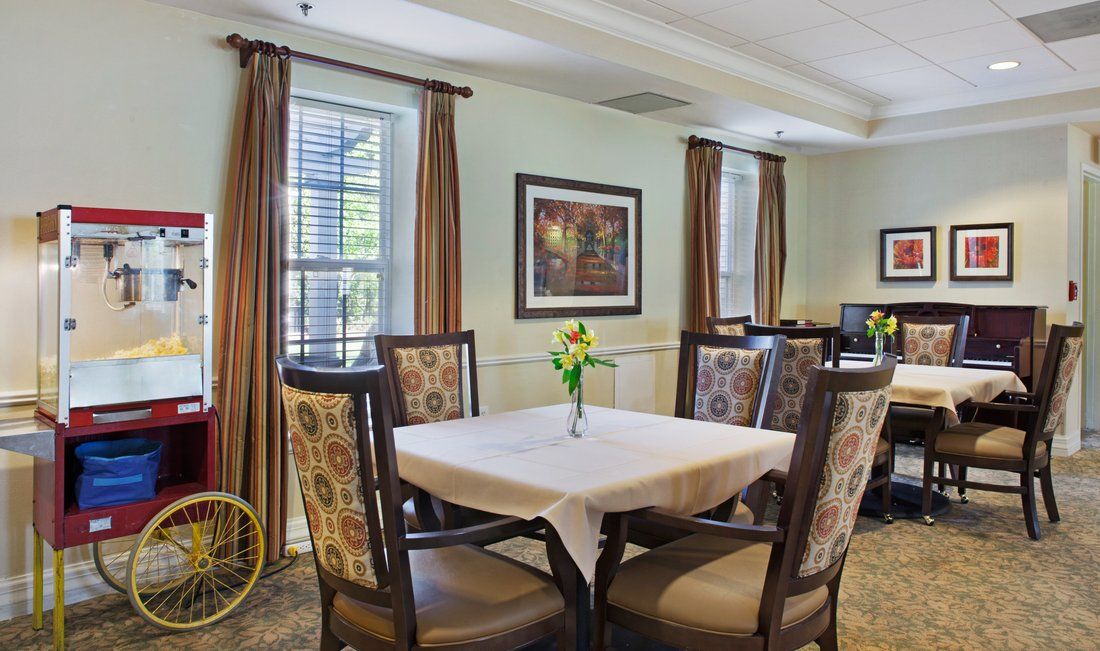 A cozy dining area with a table set for four, featuring elegant chairs and tasteful decor.