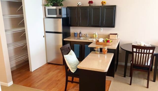 A modern kitchen with sleek black cabinets and a compact layout.