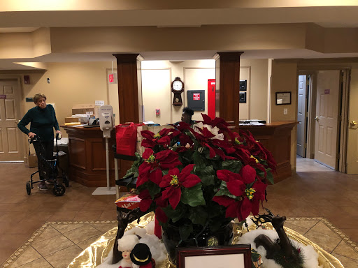 A cozy reception area beautifully decorated with holiday poinsettias, creating a warm festive ambiance.