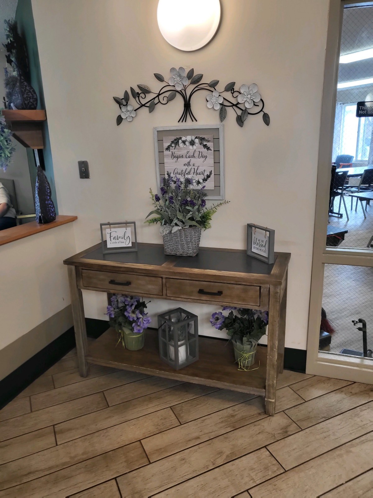 A rustic console table adorned with decorative elements and indoor plants, enhancing the entryway with charm.
