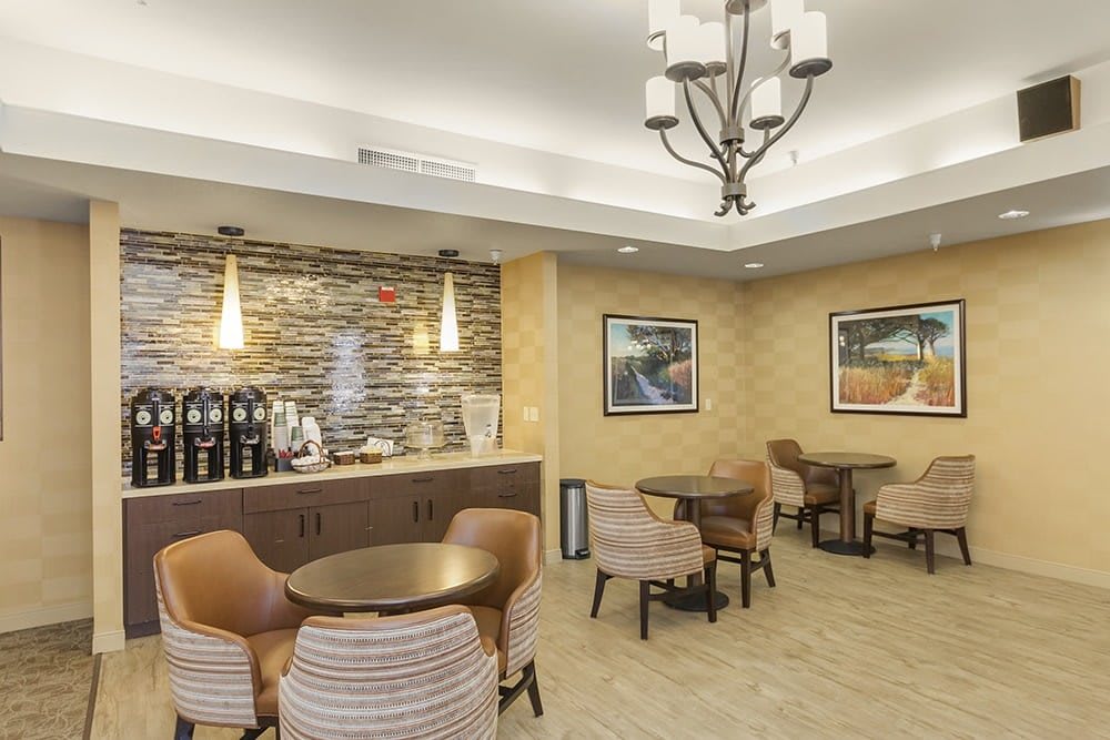 A cozy indoor seating area with a coffee station and modern decor.