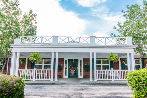 A charming facade of a house showcasing classic architectural features and inviting landscaping.