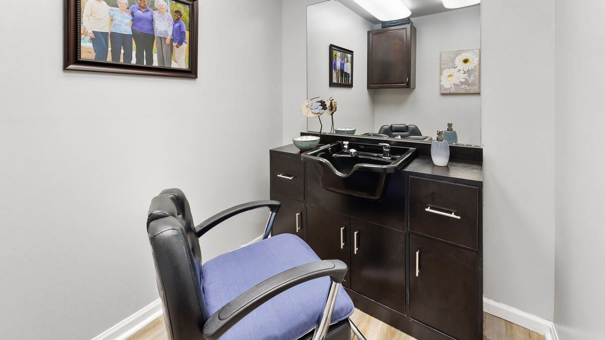 A well-organized hair salon station with a chair, mirror, and sink.