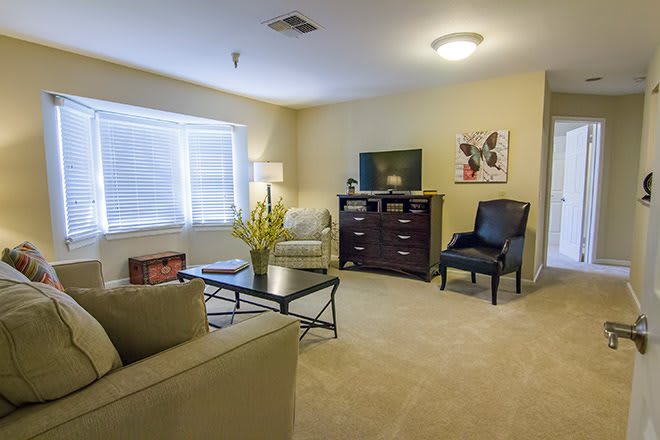 A cozy living room with modern furniture and neutral tones.