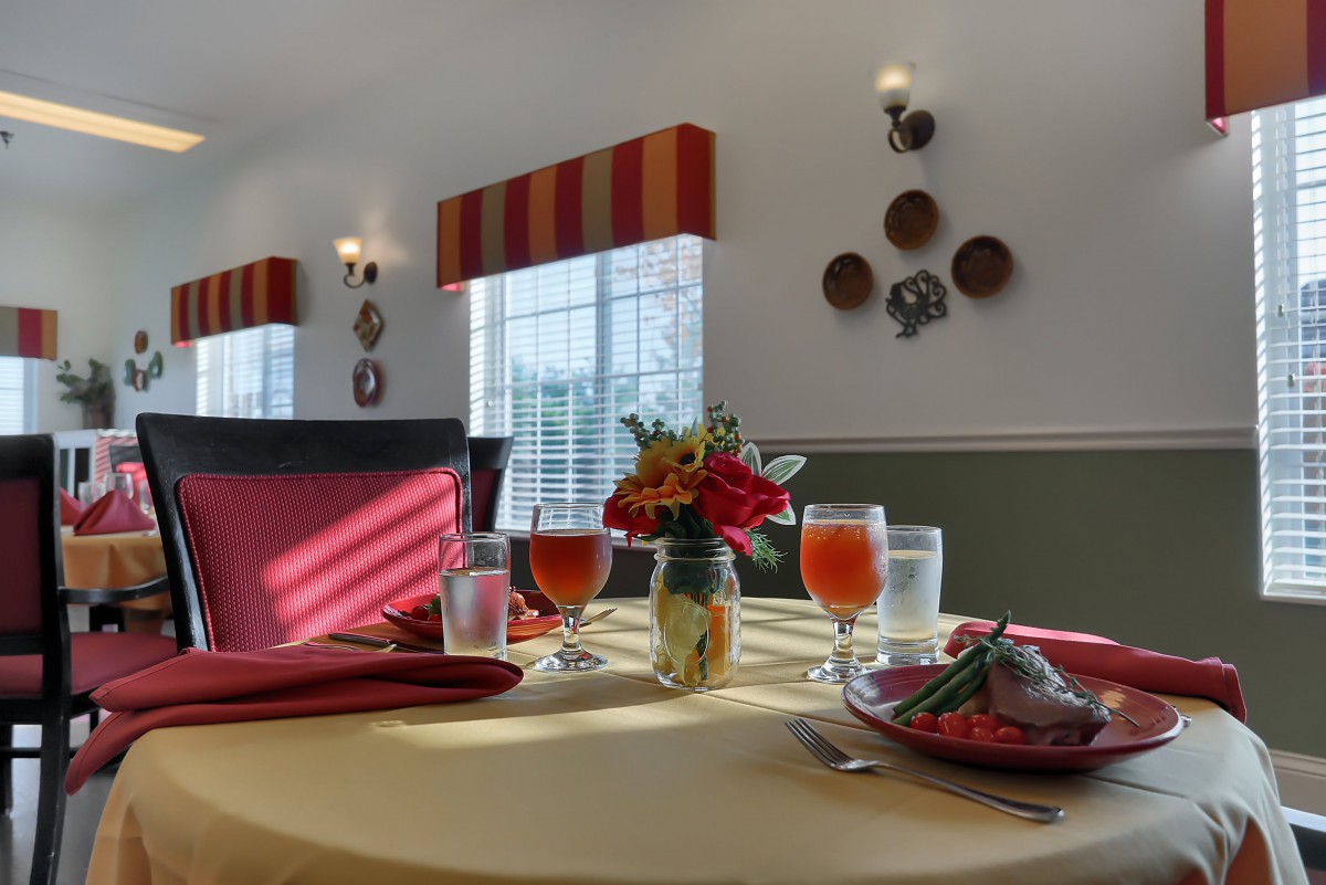 A beautifully set dining table with floral centerpiece and elegant decor.