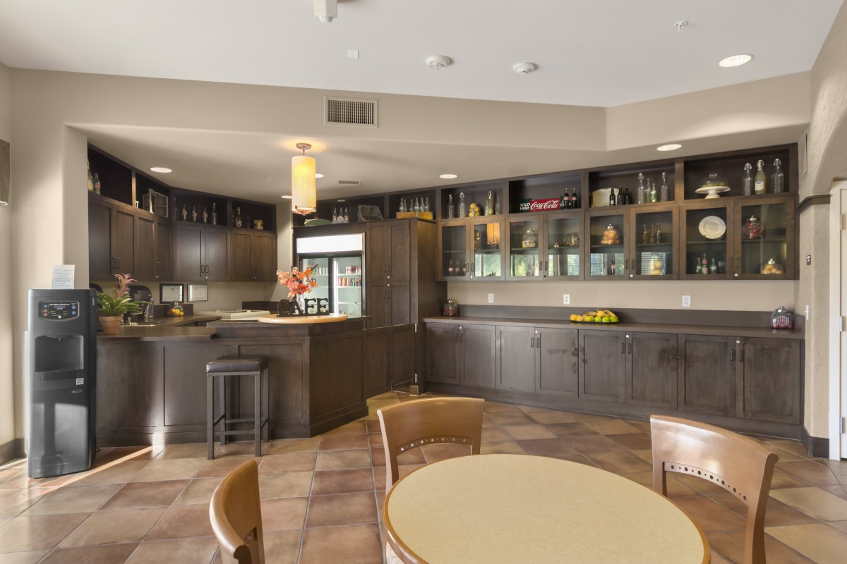 Modern kitchen cafe area with wooden cabinets and seating.