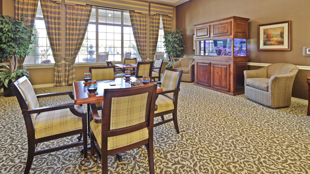 A cozy lounge with elegant seating and large windows.