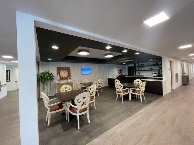A modern cafe interior with neatly arranged tables and chairs, featuring a stylish decor.