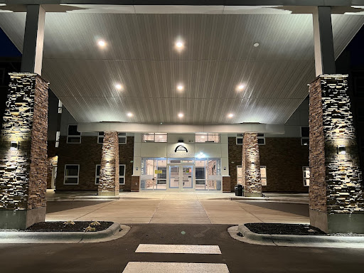The illuminated entrance of a modern building at night.