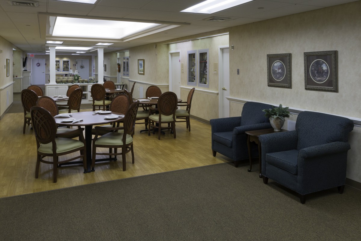 A spacious lounge area with tables, chairs, and comfortable seating.