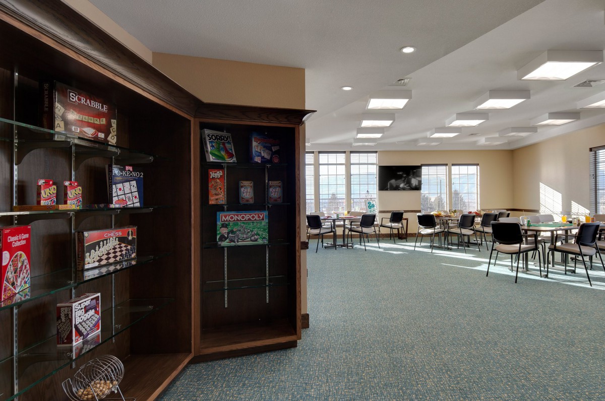 A well-lit meeting room with a display case and arranged chairs.