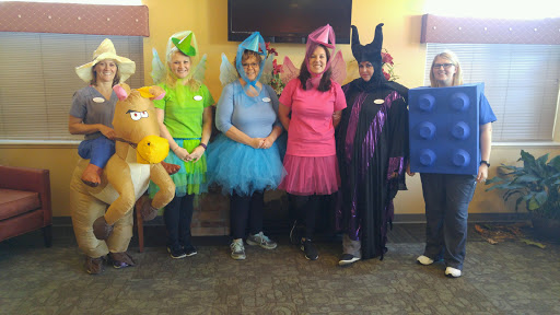 A group of individuals dressed in colorful costumes, embodying various fairy tale characters for a festive occasion.