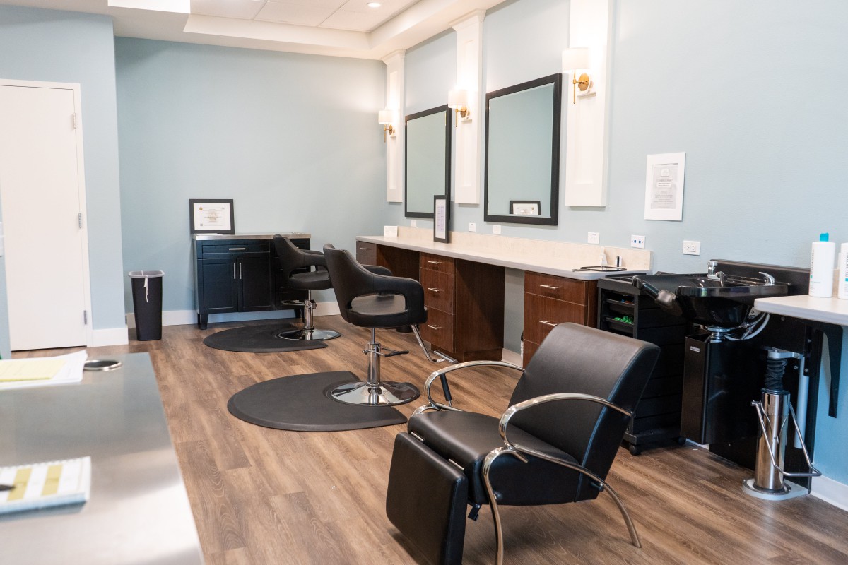 A modern hair salon interior with styling chairs and mirrors, ready for clients.