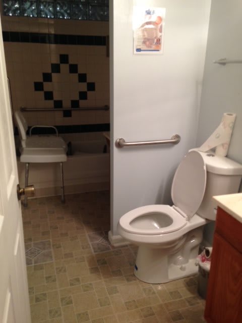 An accessible bathroom with a toilet and grab bars.
