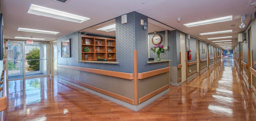 A well-designed reception area with a warm aesthetic, featuring wooden flooring and shelves.