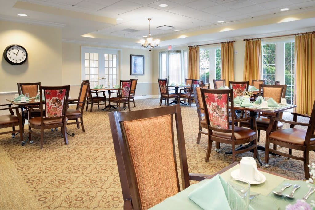 A spacious dining room with elegant furniture and decor.