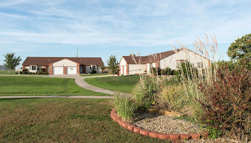 A serene suburban landscape featuring well-maintained houses and lush greenery.