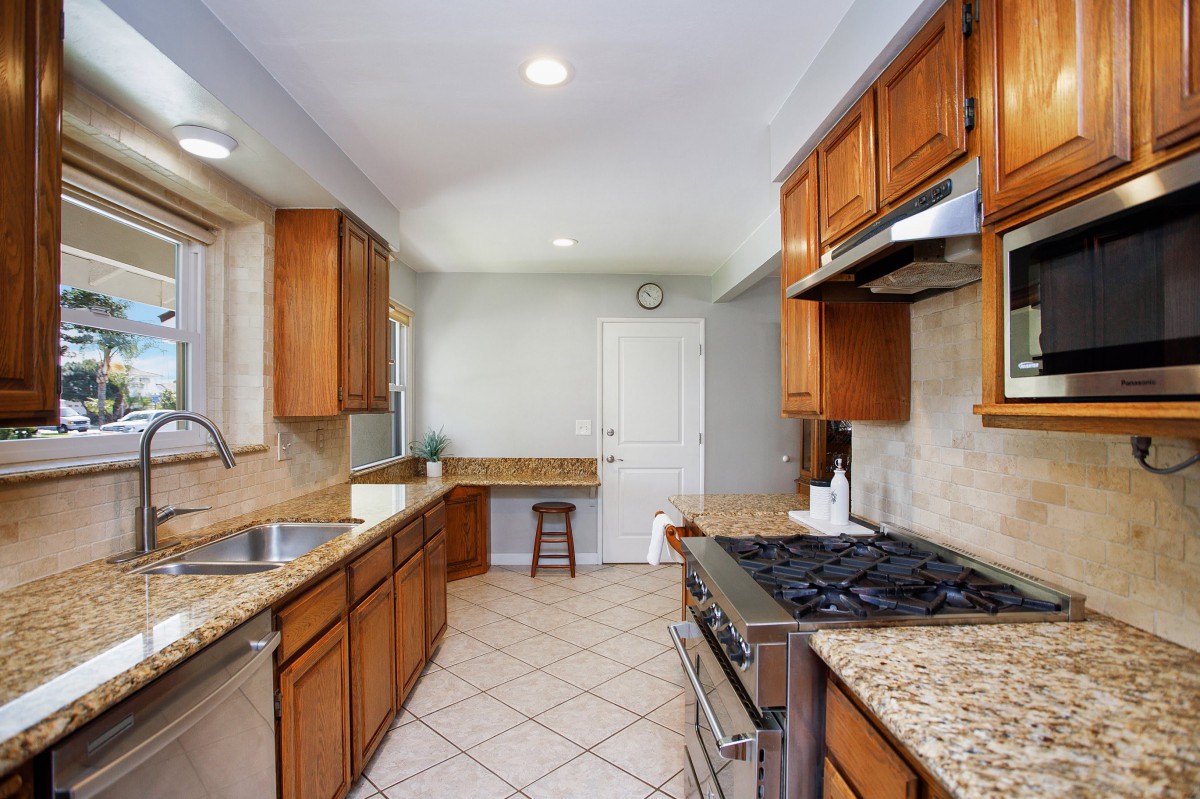 Spacious kitchen with wood cabinets and modern appliances.