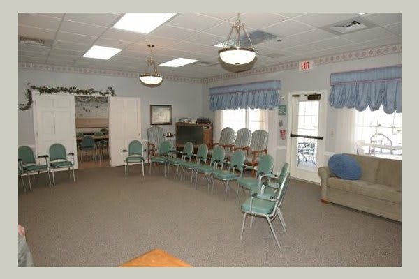 An empty meeting room with chairs arranged in a circle.