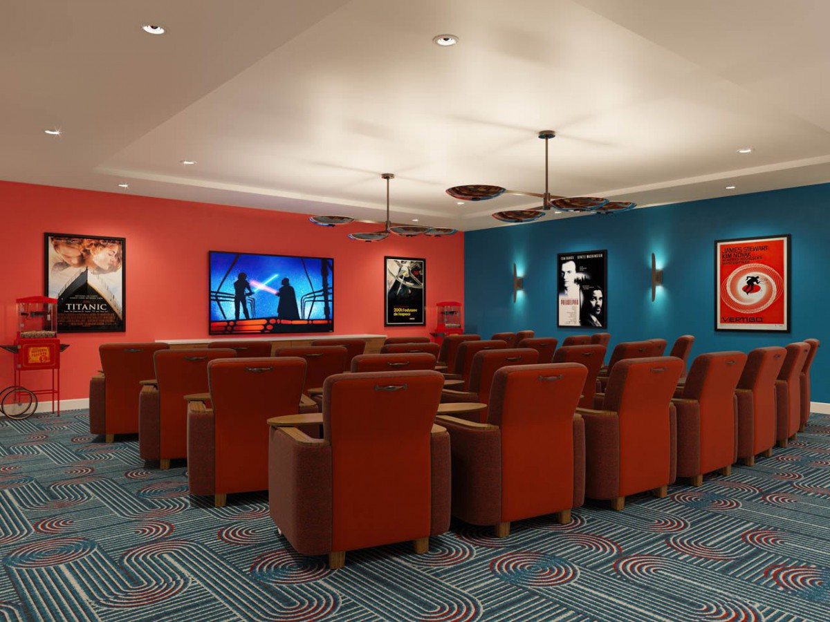 A cozy home theater room with recliner seating and colorful walls adorned with movie posters.