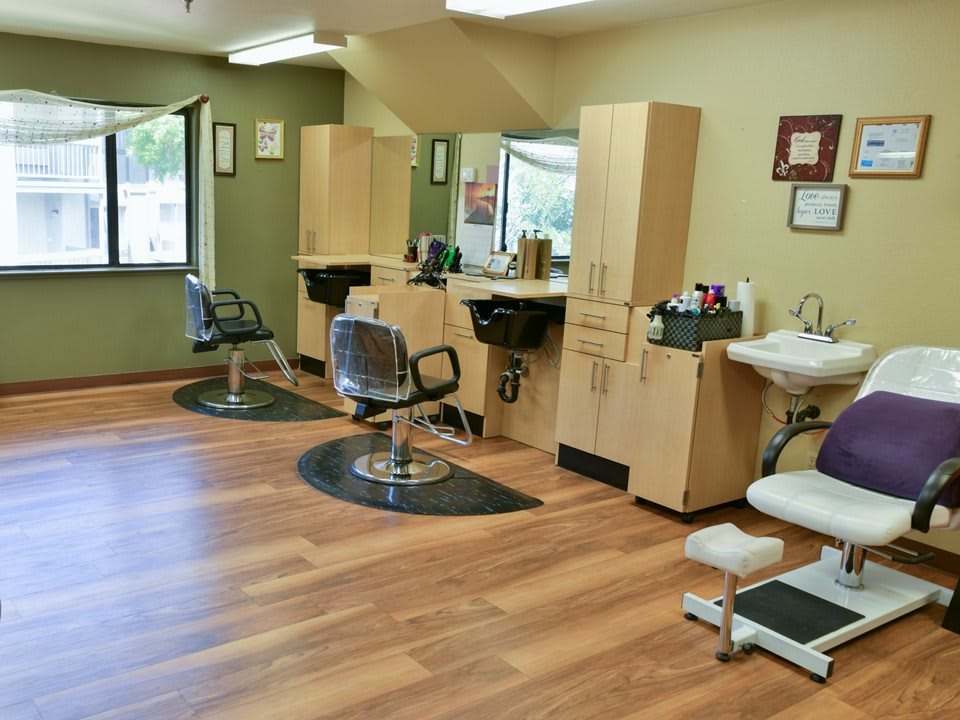 A modern hair salon interior with styling chairs and mirrors.