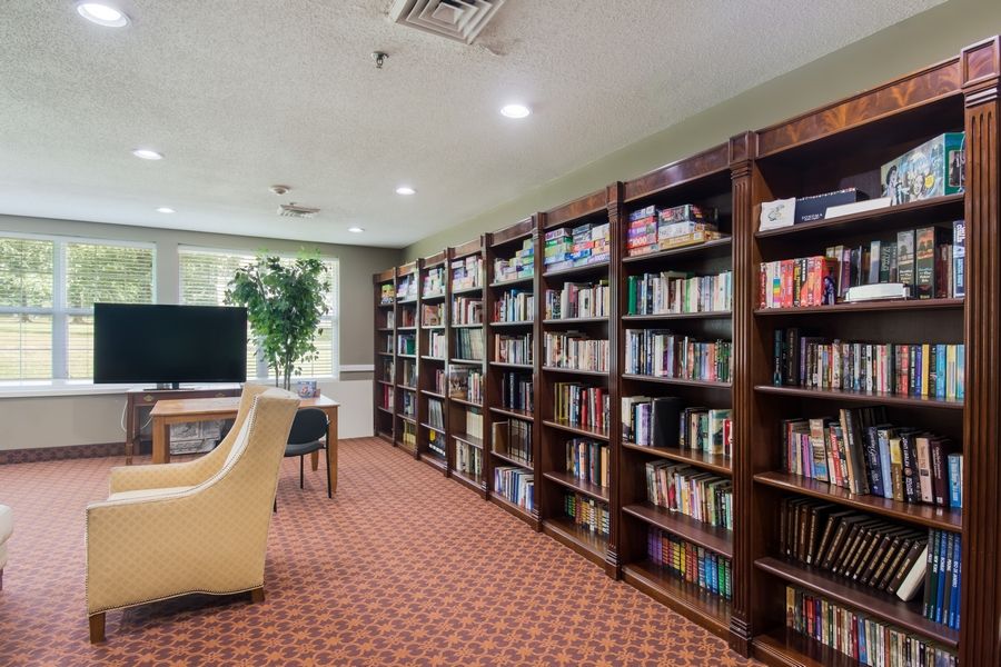 A cozy library with bookshelves and comfortable seating.