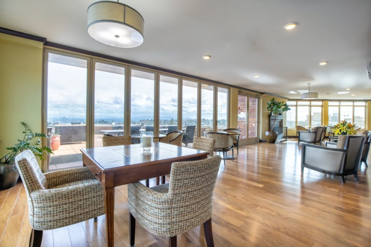 A spacious dining area with modern furniture and large windows providing ample natural light.