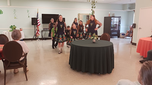 A lively group of young dancers performing Irish dance at a community event.