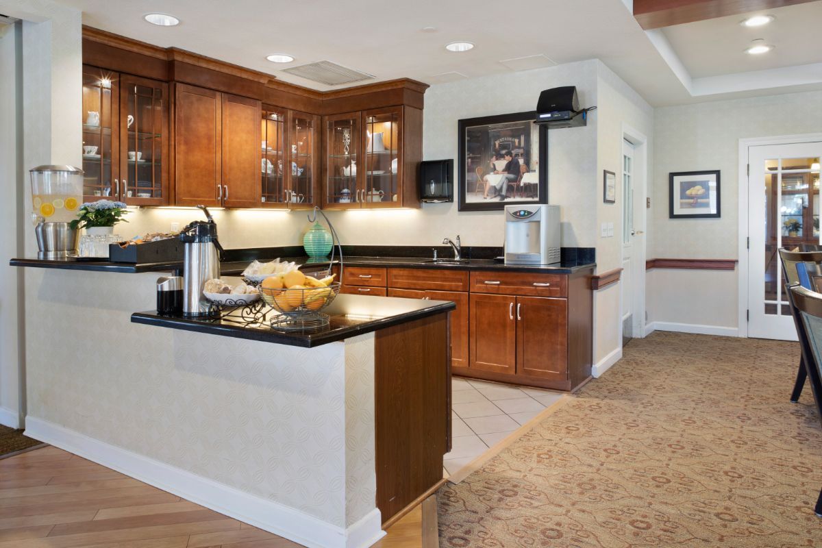 A modern kitchen with wooden cabinets and a black countertop.