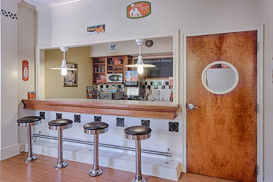 A vintage-style diner interior featuring a counter with bar stools.