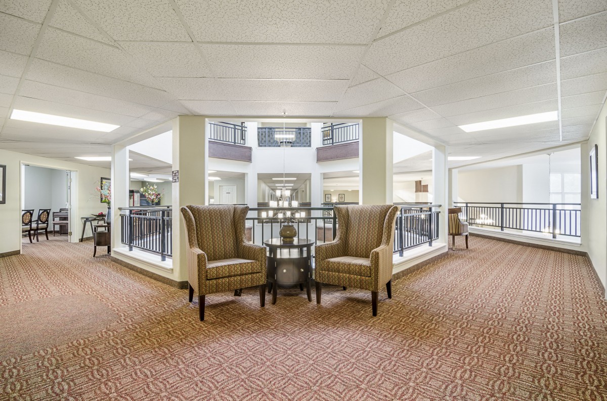 A cozy seating area in a hotel lobby with two chairs and a small table.