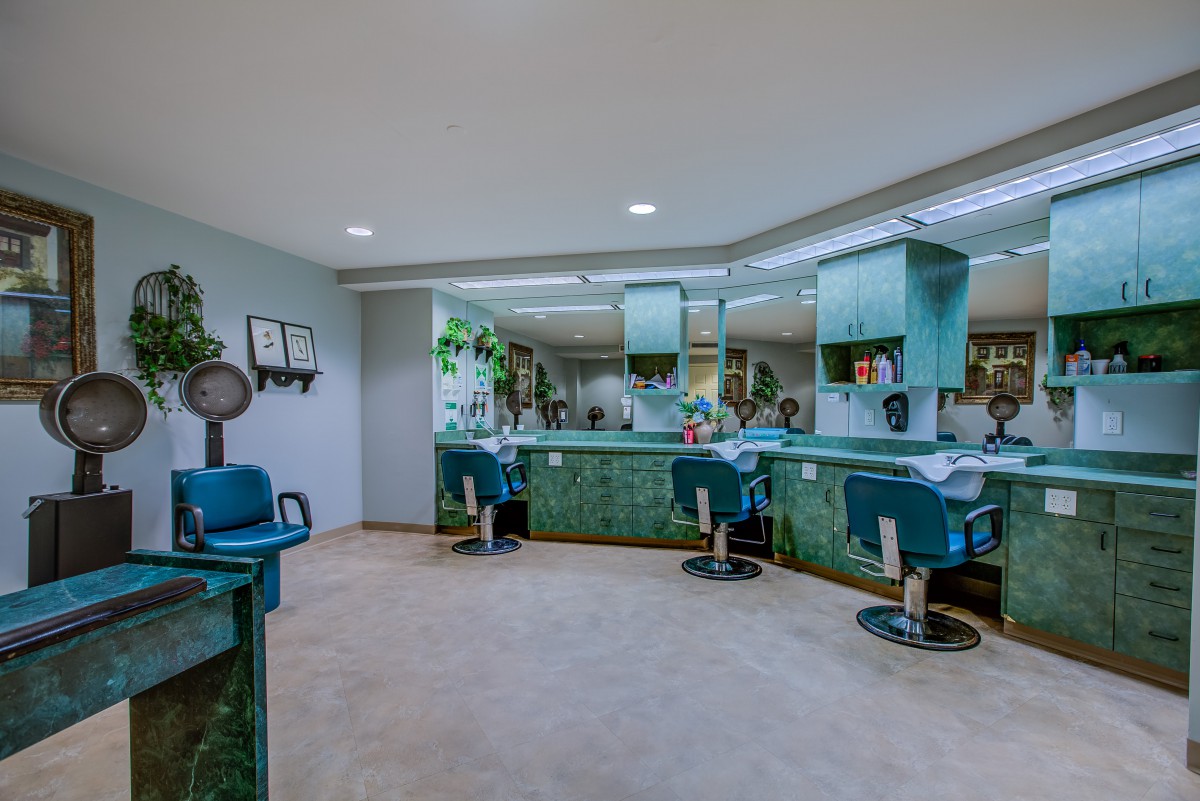 A modern salon interior with stylish chairs and mirrors.