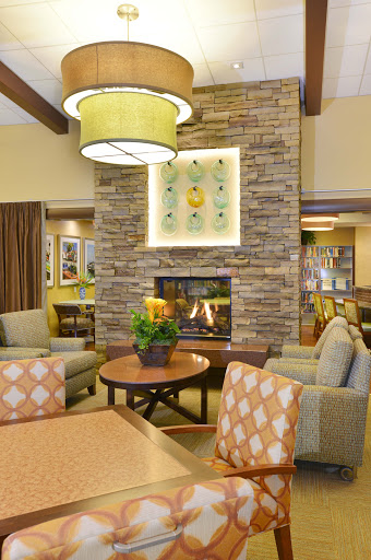 A cozy lounge area featuring a stone fireplace and comfortable seating, perfect for relaxation.