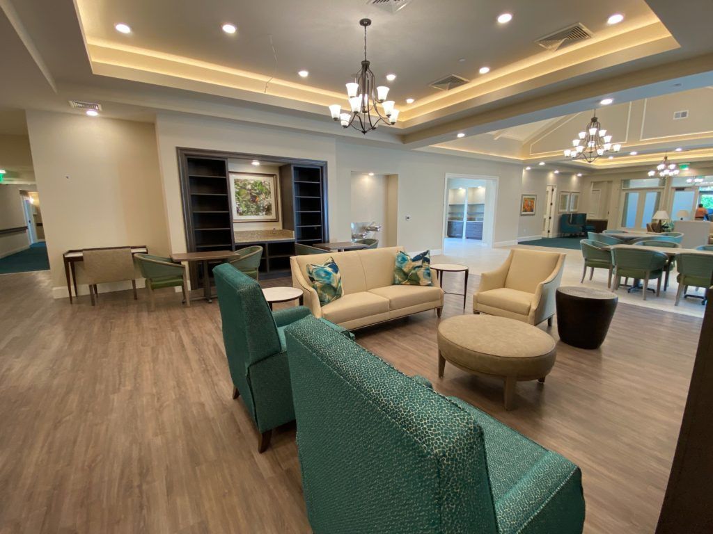 A modern lounge area featuring comfortable seating and elegant chandeliers.
