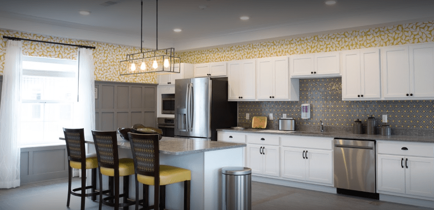 Modern kitchen with white cabinets, stainless steel appliances, and a stylish kitchen island.
