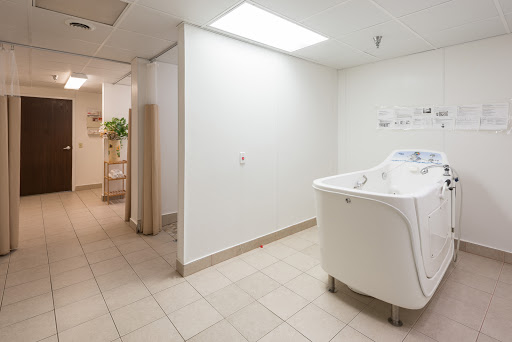 A bright and clean laundry room featuring a washing machine and tiled flooring.