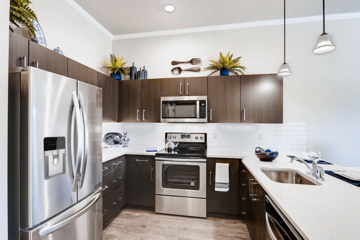 A modern kitchen with stainless steel appliances and sleek cabinetry.