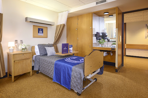 A well-furnished hospital patient room, designed for comfort and functionality.