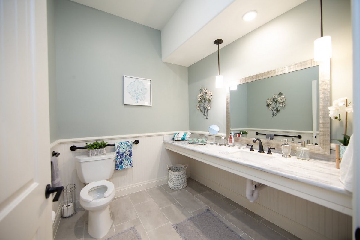 A modern, clean bathroom with a large mirror and stylish fixtures.