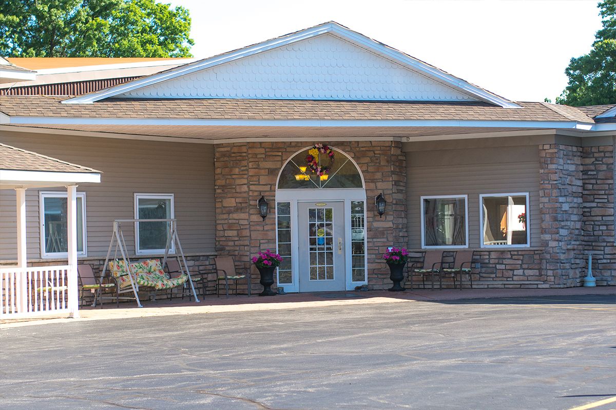 Front view of a building with a covered entrance and decorative elements.