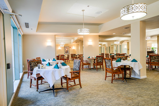 A beautifully arranged dining area featuring elegant tables and chairs, ready for guests.