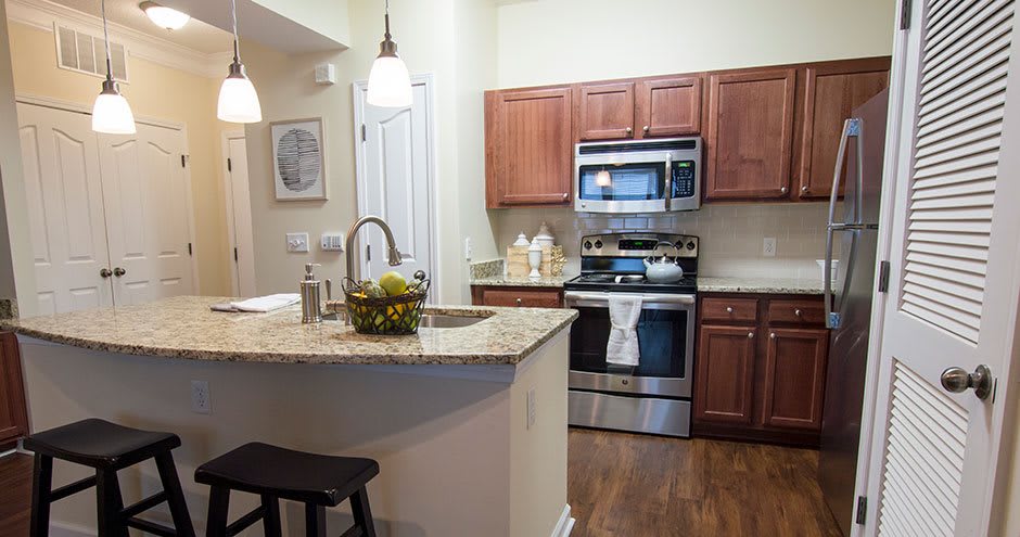 A modern kitchen with wooden cabinets and stainless steel appliances.
