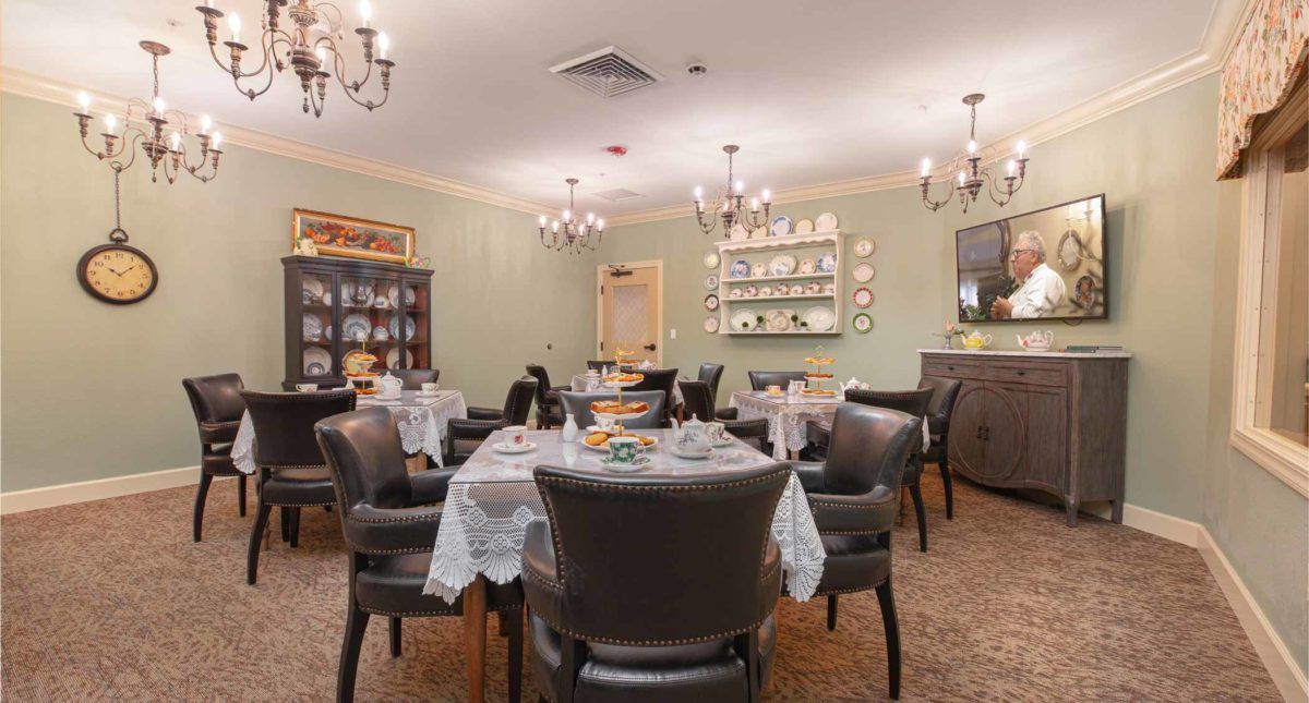 Elegantly furnished dining room with tables set for guests.