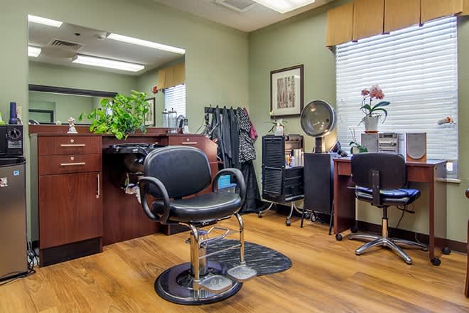 A well-organized hair salon with a comfortable barber chair and stylish decor.