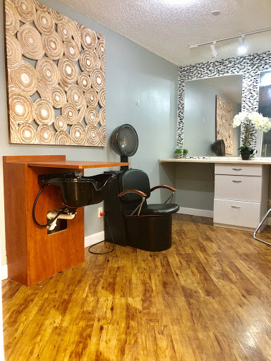 A beautifully designed hair salon space with a stylish chair and modern decor.