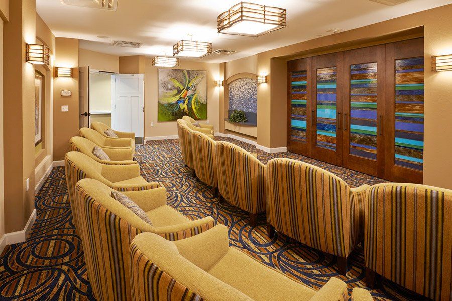 A cozy theater room with comfortable seating, decorative lighting, and artwork on the walls.
